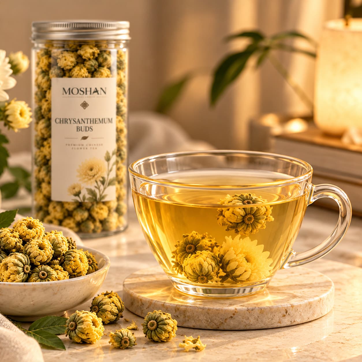 A glass jar of chrysanthemum buds with a MOSHAN label, a bowl of buds and a glass cup of infusion with opened flowers.